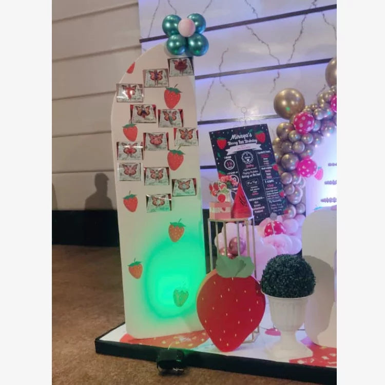 Order Berry First Birthday Decor with strawberry-themed photo memory display and balloon decorations