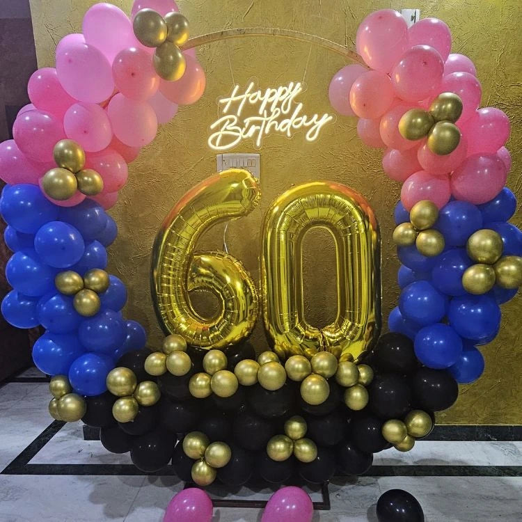 Book birthday balloon decoration at home with foil number balloon backdrop setup