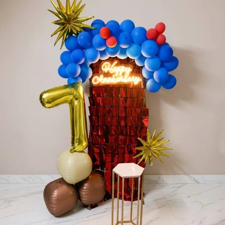 Blue and red anniversary decoration at home with balloon backdrop and neon sign