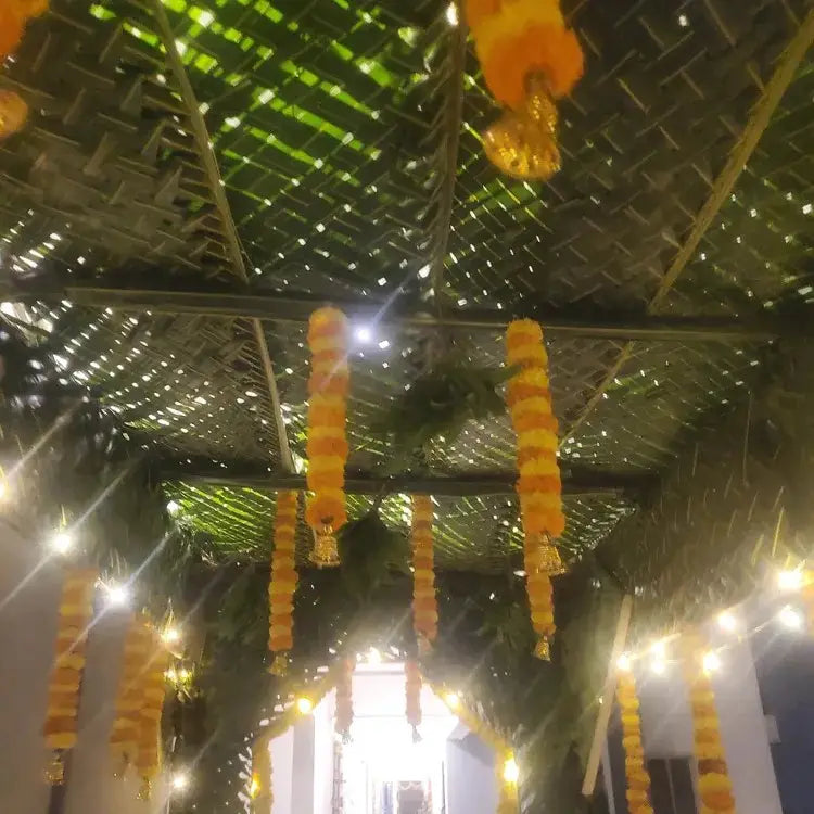 Get Chapra Decoration with natural coconut leaf roofing and hanging chrysanthemum garlands