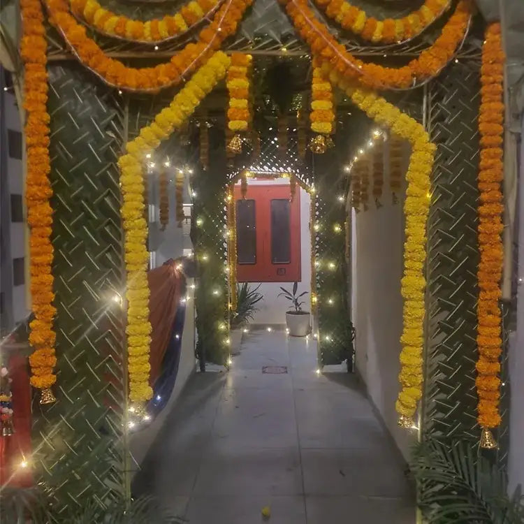 Chapra Decoration with marigold garlands, a chrysanthemum, a leaf canopy, and warm lighting
