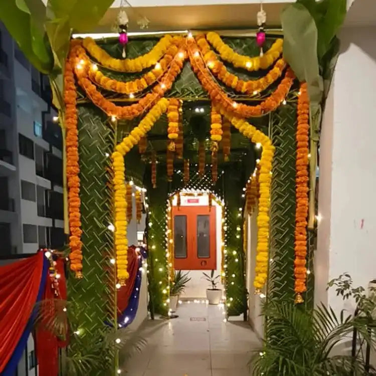 Book Chapra Decoration with coconut leaves, floral garlands and lighting for wedding entrance