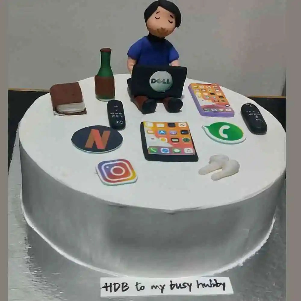 Order a custom birthday cake for husband featuring a laptop, phones, and a personalized name