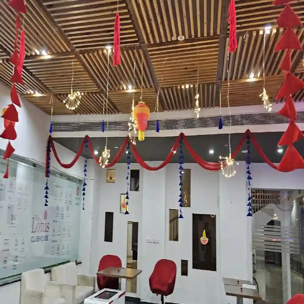 Order Diwali Decor in Office with red and blue fabric hangings, lanterns and festive ceiling decorations