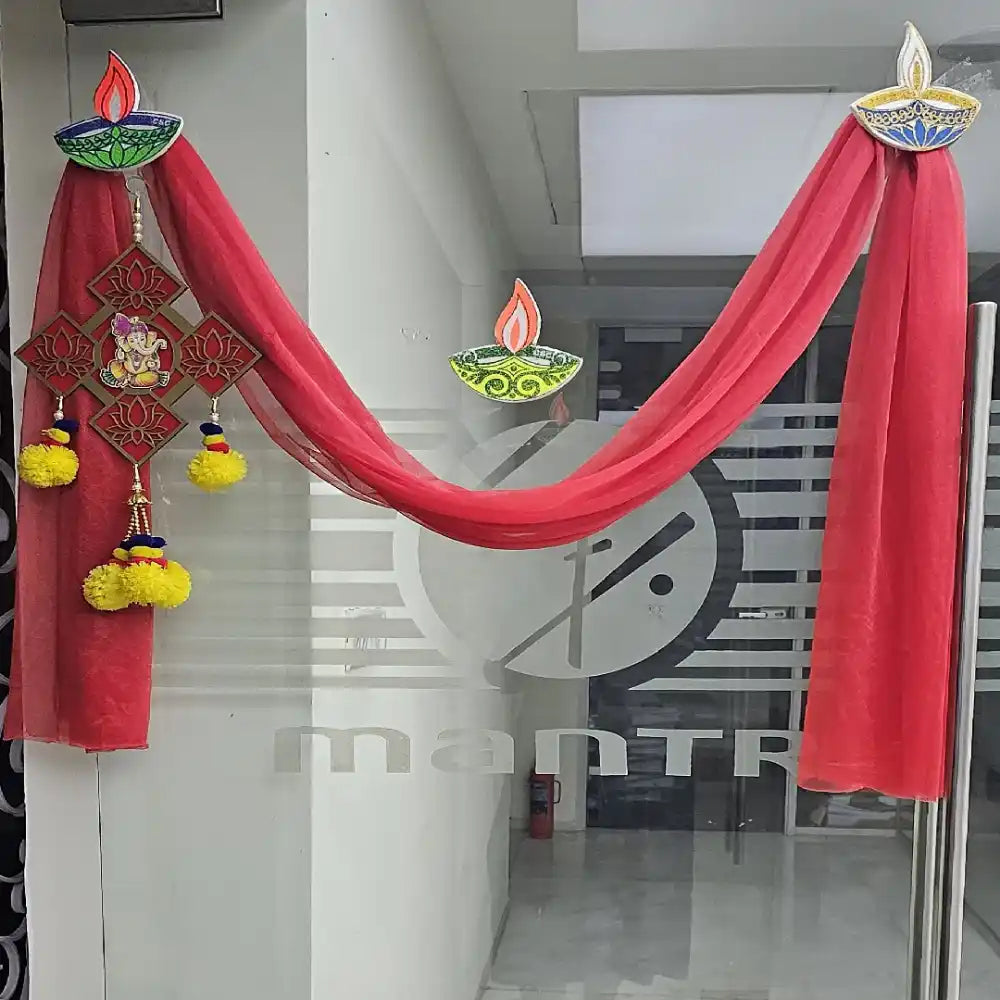Order Diwali Decor in Office with traditional diya wall hangings and red fabric entrance decoration
