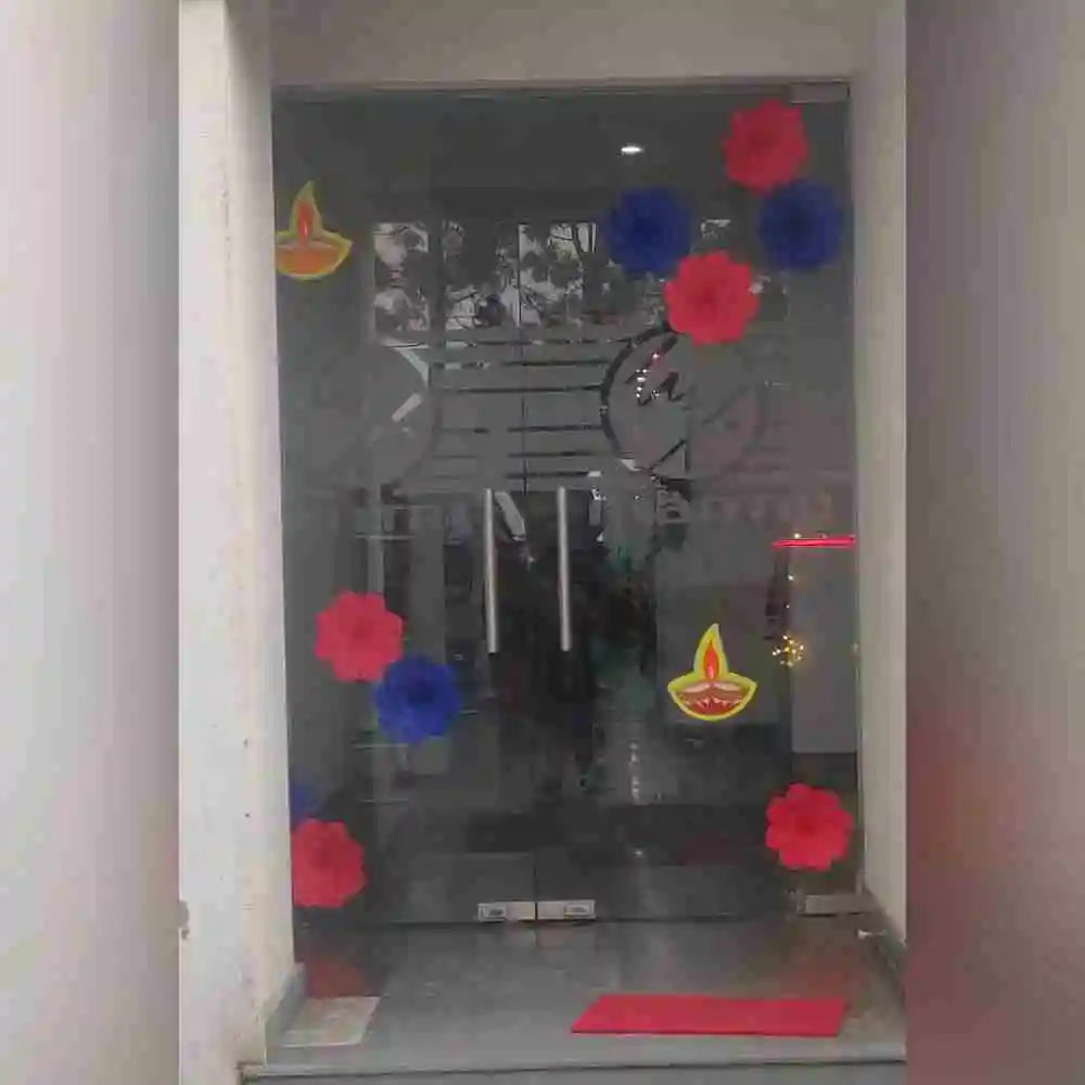 Order Diwali Decor in Office with festive diyas, red and blue paper flowers and entrance door decorations