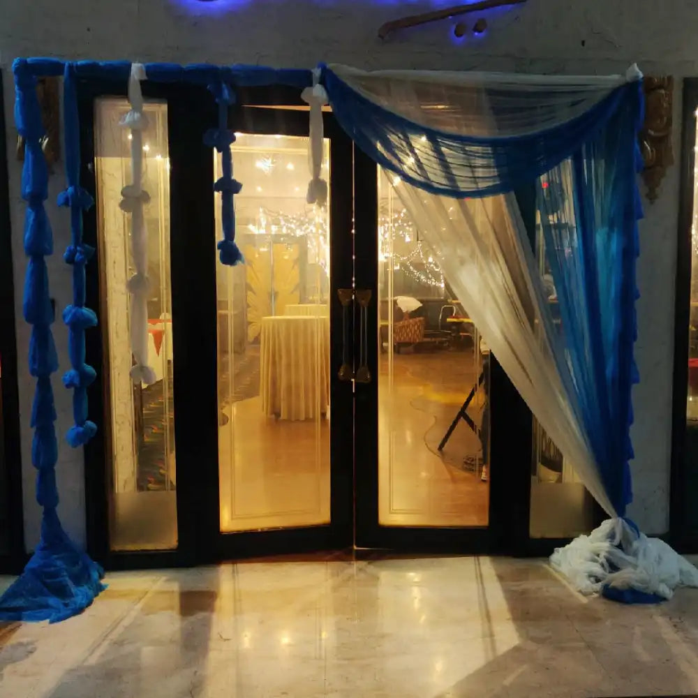 Book Elegant Floral Wedding Decor with blue and white entrance drape setup