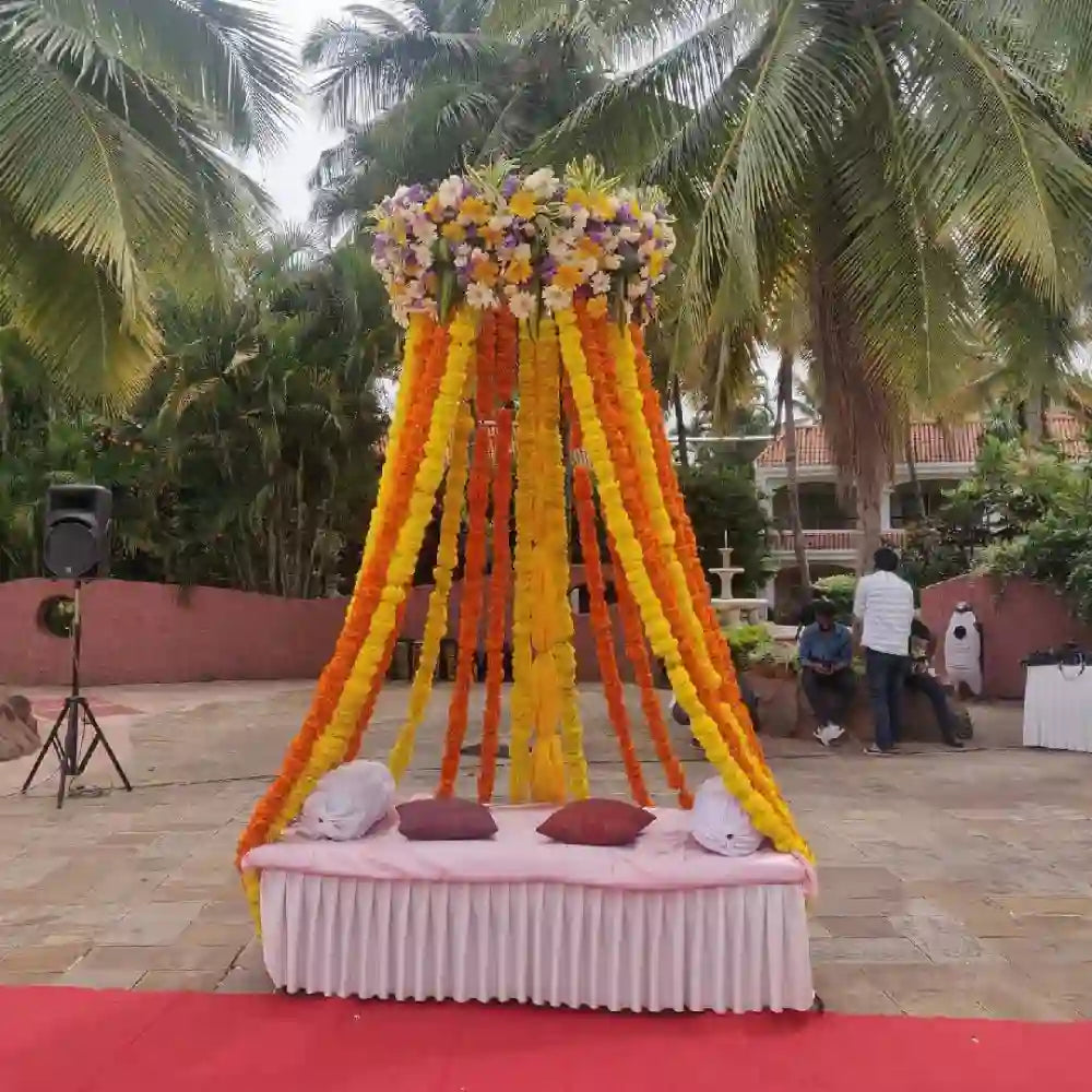 Get Elegant Floral Wedding Decor with colourful floral pillar and diwan setup