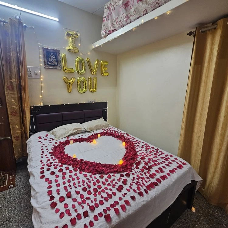 Order first night room decoration with rose petal heart and romantic lighting