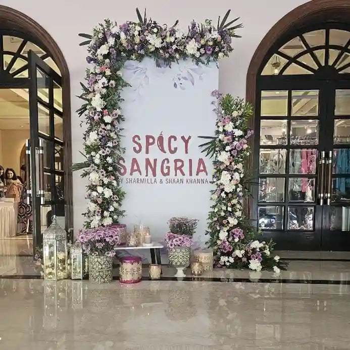 Book floral event welcome board with decorative candles and flower pots
