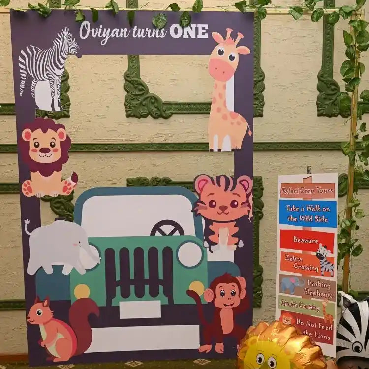 Get jungle safari birthday decor package with animal-themed photo booth backdrop and jeep prop