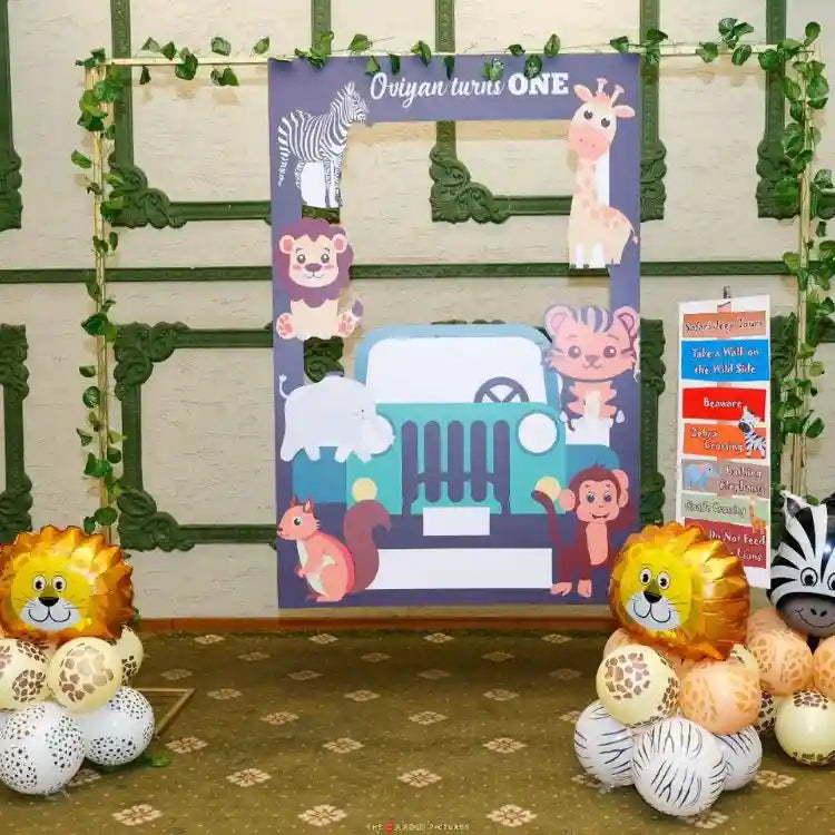 Get a jungle safari birthday decor package with animal photo booth and balloon decorations setup