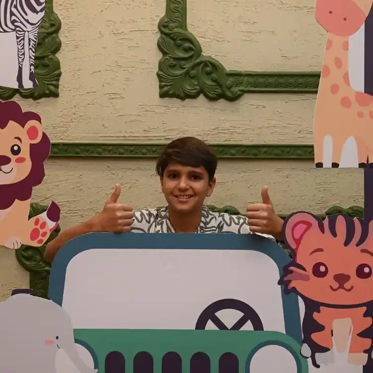 Get jungle safari birthday decor package with safari jeep photo booth prop