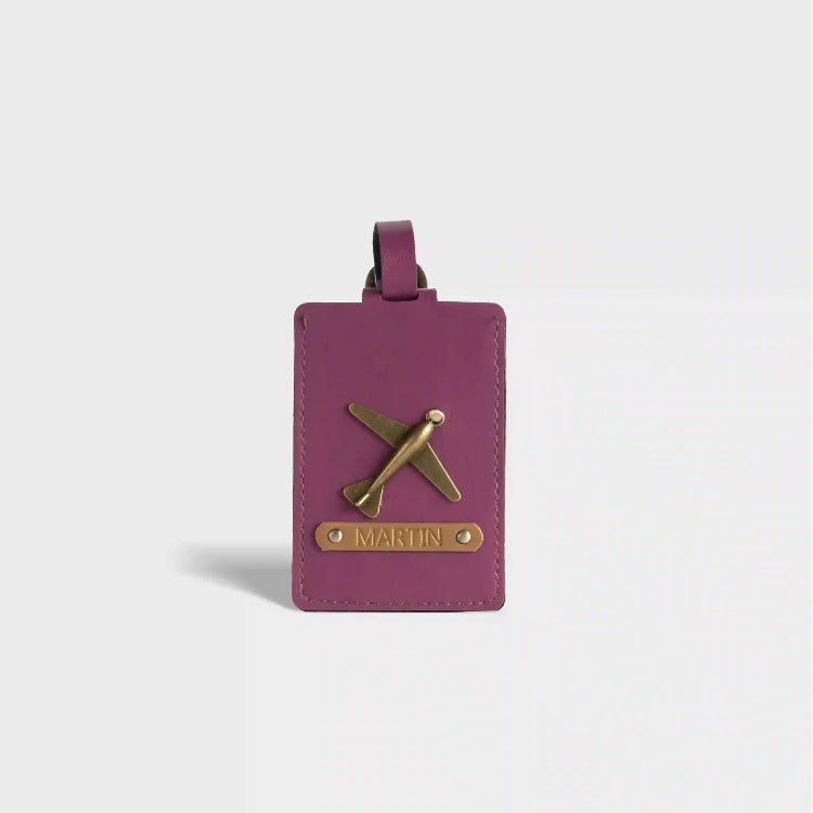 Shop Personalized purple luggage tag with charm and embossed name.