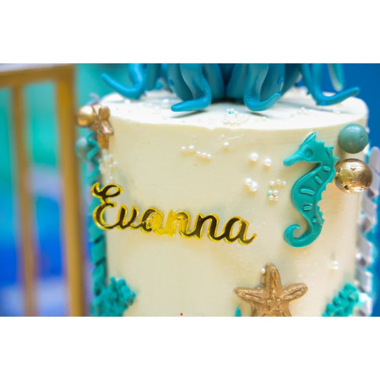 Book Under the Sea Birthday Decor with personalized ocean-themed cake featuring seahorse and starfish details