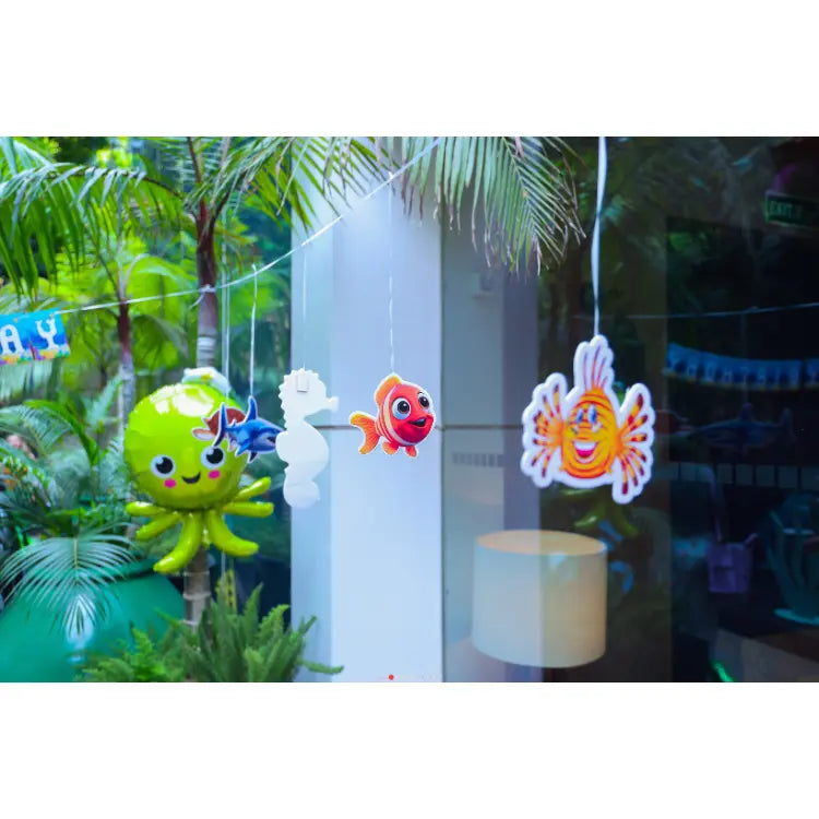 Book Under the Sea Birthday Decor with hanging octopus, fish and sea-themed cutouts