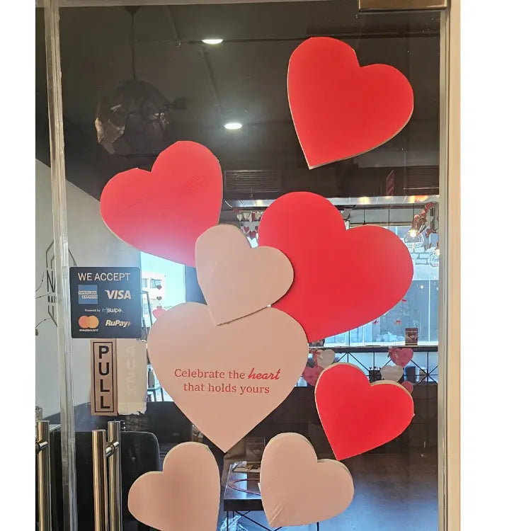 Book Valentine's Day heart decoration on glass entrance door