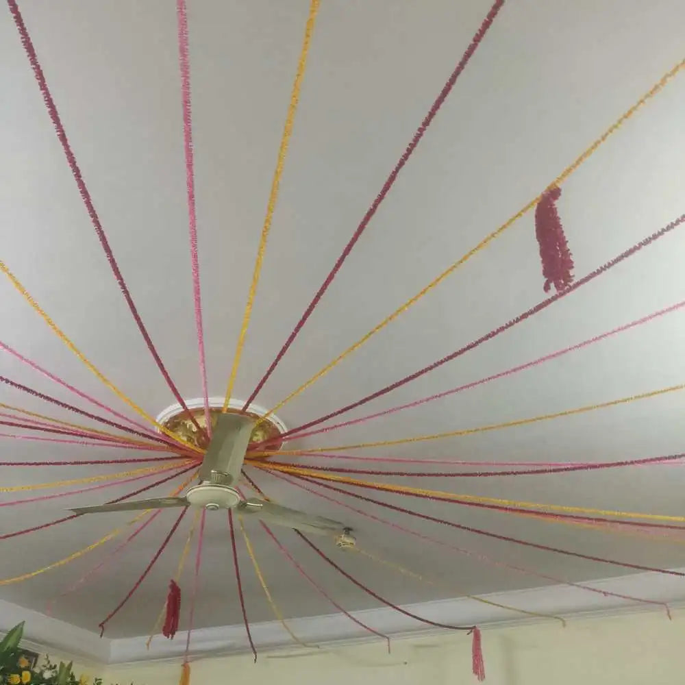 Book Wedding Floral Decor at Home with colourful ceiling ribbons and hanging tassel decorations
