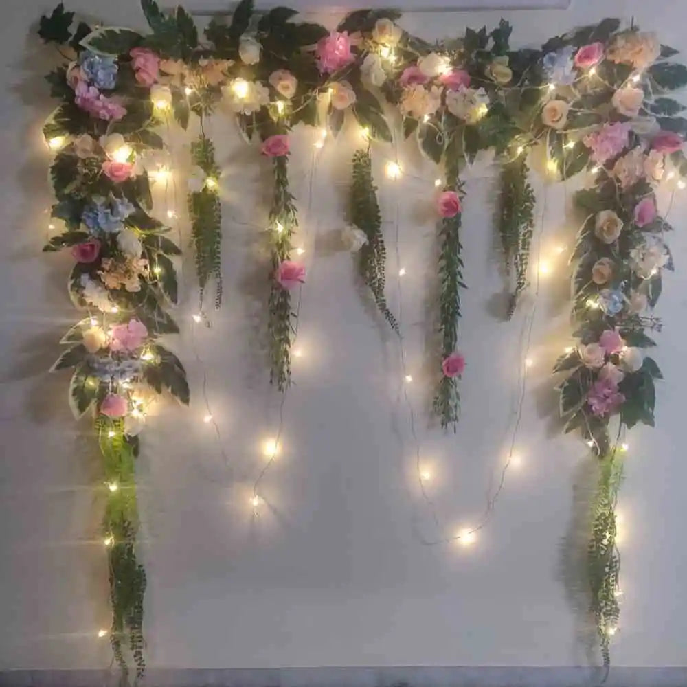 Book Wedding Floral Decor at Home with floral backdrop, artificial plants and warm string lights