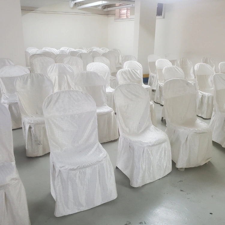 Hire white Christmas office event setup with covered chairs for corporate celebrations
